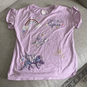 Purple shirt with words and designs.